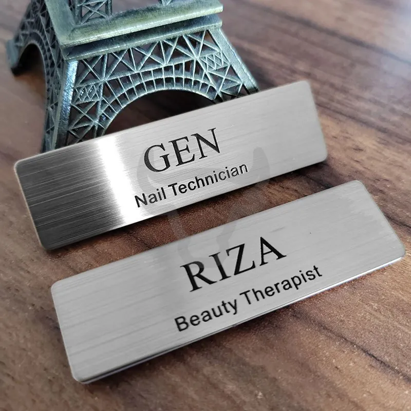 Brushed metal nameplates showing fine printed detail.