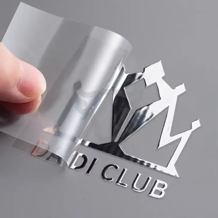 Metallic transfer detail being lifted from a carrier film.